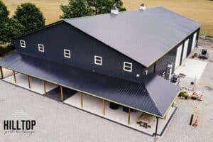 An aerial view of a commercial pole building with a black roof